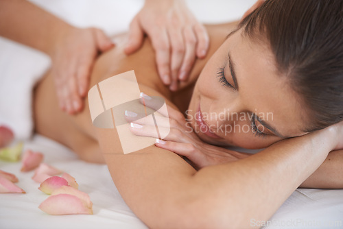 Image of Hands, massage and woman at spa to relax, peace and calm at luxury resort for aromatherapy with flowers. Closeup, therapy and person at salon to pamper body, skincare and beauty treatment for health