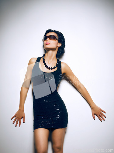 Image of Woman, fashion and style in studio with confidence for sunglasses for white background, mockup space or dress. Female person, accessories and clothes as model in America for edgy, trend or outfit