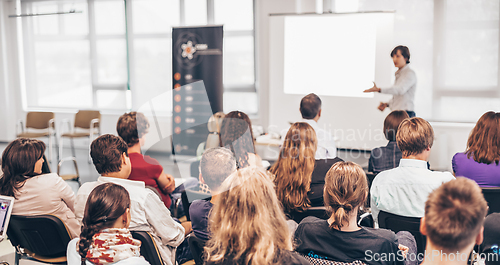 Image of Woman giving presentation on business conference.