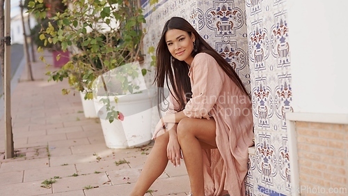 Image of Serene Woman Relaxing in a Tranquil Spanish Street
