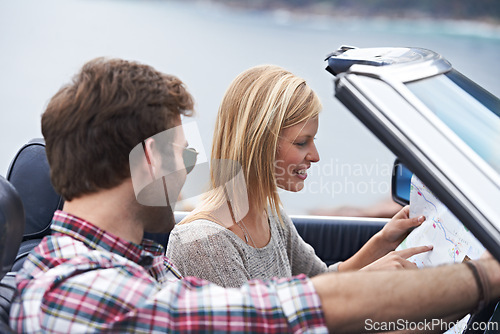 Image of Map, travel and couple in a car for transportation to vacation, adventure or holiday destination. Reading, navigating guide and people on journey in vehicle driving for weekend road trip together.