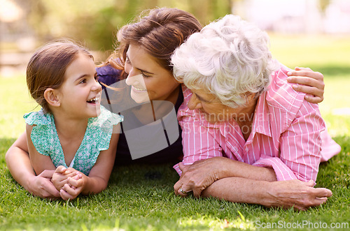 Image of Grandmother, mom and child hug outdoor to relax in summer, holiday or vacation together. Happy, family and elderly mother smile on grass with kid in garden with love and support in retirement