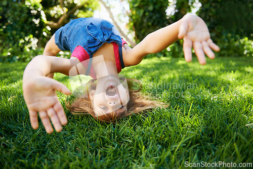 Image of Child, back and bend or bridge for play in summer or flexibility game or practice, fun or backyard. Kid, face and hands or gymnastics stretching with head balance on grass in London, happy or garden