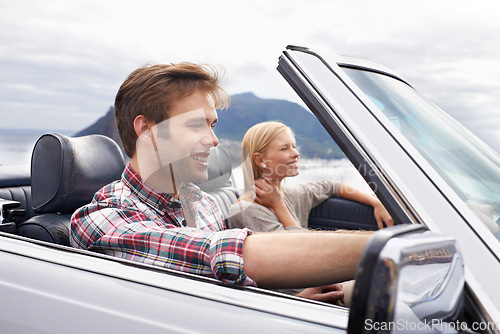 Image of Couple, convertible and driving on mountain road in nature for bonding adventure for holiday, journey or travel. Man, woman and car in California for vacation destination or connection, trip or view