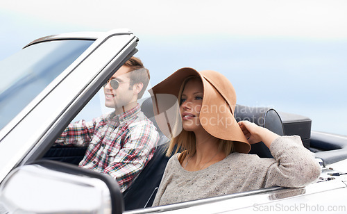 Image of Couple, convertible and driving on road or adventure in California or outdoor journey, sun hat or vacation. Man, woman and environment on mountain or relaxing trip with transport, weekend or happy