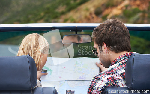 Image of Map, driving and back of couple in a car for travel to vacation, adventure or holiday destination. Reading, atlas guide and young man and woman on journey in vehicle for weekend road trip together.