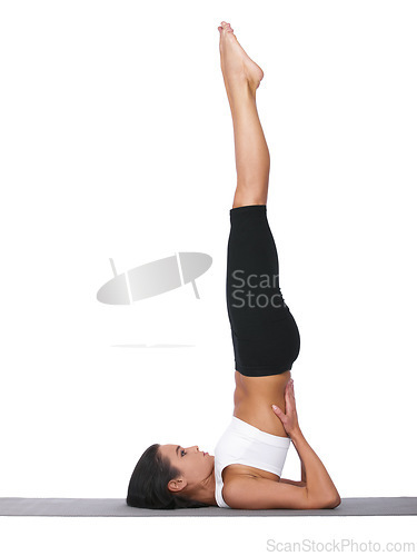 Image of Woman, yoga and stretching in pilates workout, exercise or training on a white studio background. Female person or yogi in warm up, balance or shoulder stand pose for zen or fitness on mockup space