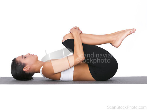 Image of Woman, yoga and stretching body for exercise, training or workout on a white studio background. Calm female person or yogi in warm up, balance or wind pose for zen, pilates or fitness on mockup space