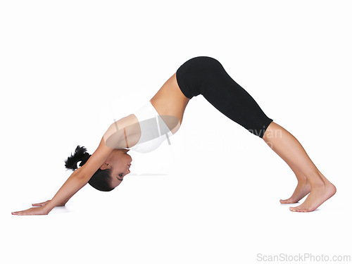 Image of Woman, yoga and stretching body in workout, exercise or training on a white studio background. Young female person or yogi in warm up, balance or pose for zen, pilates or fitness on mockup space