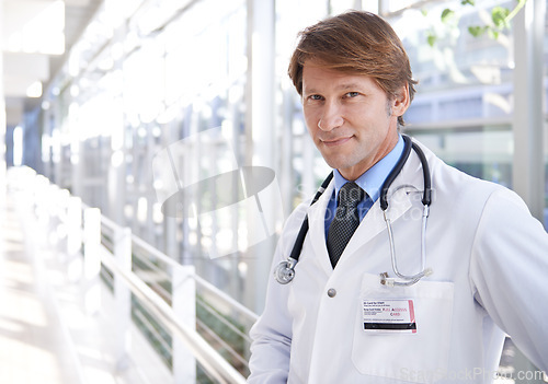 Image of Smile, pride and portrait of doctor in hospital with positive, good and confident attitude. Happy, medical career and face of professional mature male healthcare worker in medicare clinic corridor.