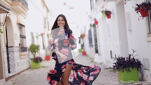 Image of Elegant Woman Twirling in Floral Dress on Spain Street