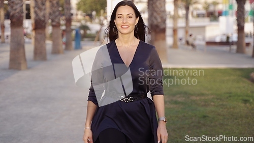 Image of Elegant Woman in Black Dress Walking in Spain
