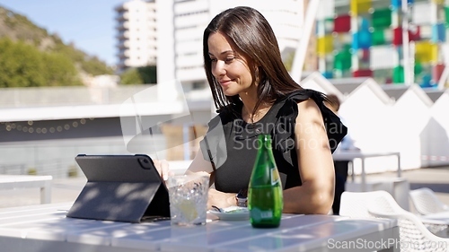 Image of Professional Woman Working on Tablet Outdoors in Spain