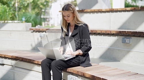 Image of Professional Woman Working Outdoors on Laptop