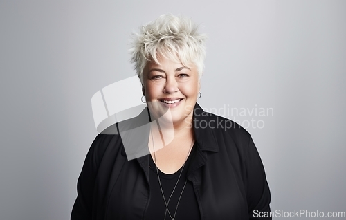 Image of On a grey backdrop, a plump elderly blonde exudes confidence and charm, embracing her full-figured, matured grace