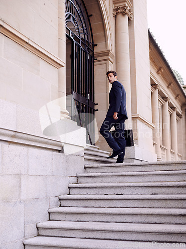 Image of Business, briefcase and man walking into law firm in city with evening commute, stairs and court building. Businessman, lawyer or attorney on outdoor steps with formal bag for urban travel from work