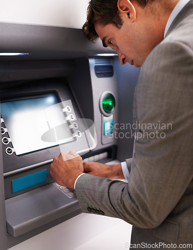 Image of Businessman, ATM and typing pin for cash withdrawal, security or privacy in financial safety at money machine. Man in business suit on electronic banking system for deposit, investment or finance