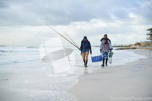 Image of Water, fishing and men walking on beach together with cooler, tackle box and holiday conversation. Ocean, fisherman and friends with rods, bait and tools at waves on winter morning vacation at sea.