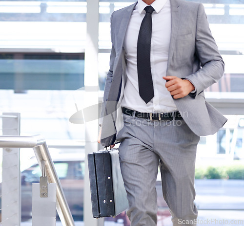 Image of Businessman, suitcase and walking with fashion for travel, immigration or rushing to office. Closeup of man or employee in stylish suit with briefcase in a hurry for business opportunity or traveling