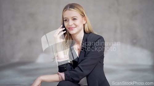 Image of Professional Woman Smiling While Speaking on Phone