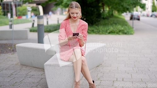 Image of Young Woman Enjoying Summer Day in Urban Park