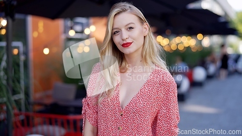 Image of Elegant Woman Enjoying Evening at Outdoor Cafe