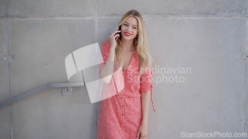Image of Stylish Woman in Red Dress Talking on Phone Outdoors