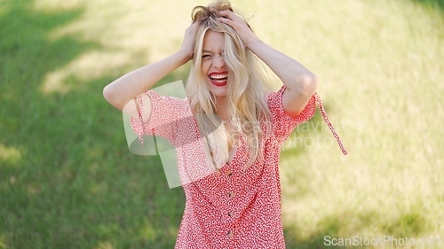 Image of Joyful Woman Enjoying Sunny Day in Flowery Dress