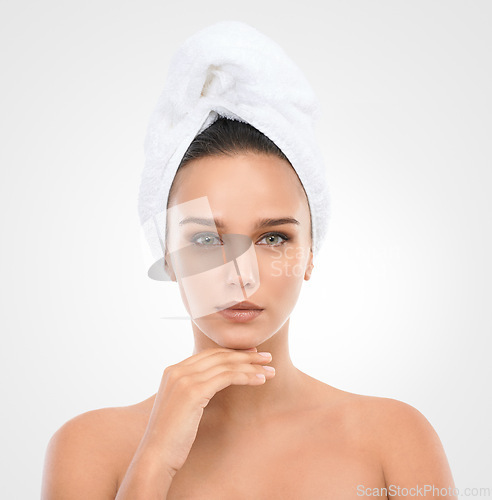 Image of Girl, skincare and face in studio with towel for natural look, cosmetics and dermatology for wellness. Woman, portrait and clean for self care, mockup and white background with serious model