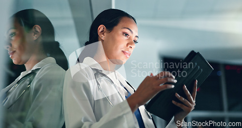 Image of Doctor, woman and tablet at night with medical, healthcare and clinic data for research. Female professional, employee and telehealth with online consulting on a web app for wellness and planning