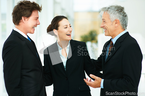 Image of Team, laugh and together in workplace of corporate company with professional suits talking to boss. CEO, happy and discussion with employees in meeting of collaboration in workforce for business