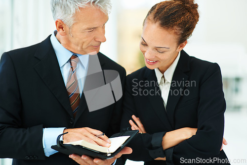 Image of CEO, showing and meeting with employee in office for business in corporate company for strategy. Woman, happy and talking to leader of workplace in professional with notebook for brainstorming