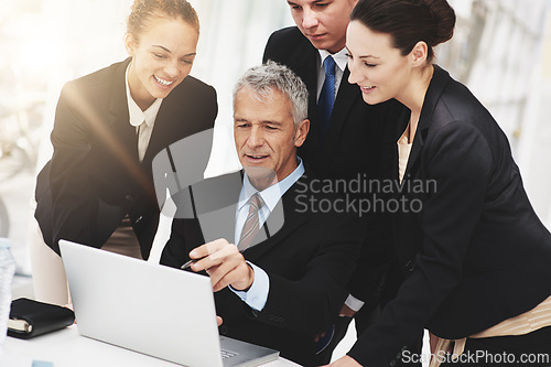 Image of CEO, collaboration and laptop with employees in office for brainstorming for company. Women, happy and talking to boss for leadership of business with technology for strategy, online and internet