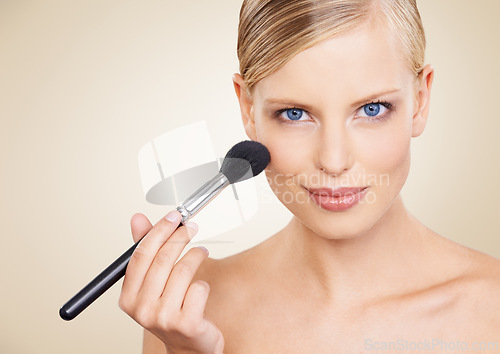 Image of Cosmetics, brush and mockup portrait of woman in studio with confidence, makeup or facial glow. Glamour, beauty and happy face of girl on beige background space with healthy skin, shine and wellness.