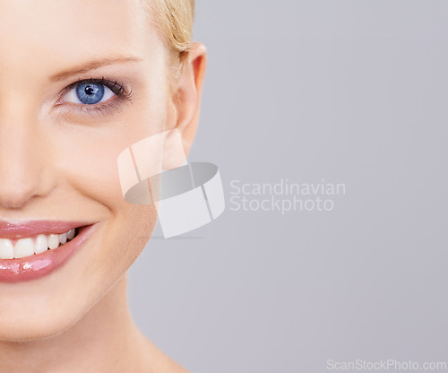 Image of Beauty, cosmetics and half portrait of woman with smile, natural makeup or facial glow in studio mockup. Happiness, skincare and face of girl on grey background space for health shine and wellness.