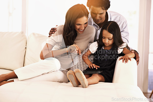 Image of Happy family, tablet and relax on sofa for entertainment, social media or games at home. Mother, father and daughter with technology for online streaming, movie or reading ebook together at house