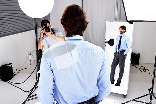 Image of Photographer, model shoot and camera in studio, behind the scenes and equipment on set for advertising. Man, back and videographer with lens or gear for image, business marketing and corporate design