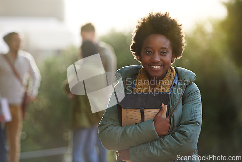 Image of Black woman, university student and portrait with book on campus for prepare, information and notes on research. Outdoor, college and knowledge with advice for test and assignment submission.