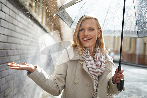 Image of Woman, umbrella and hand with rain in city, walking and surprise for splash, weather and happy in winter. Person, wow and smile with travel, journey and excited with water on sidewalk in Cape Town