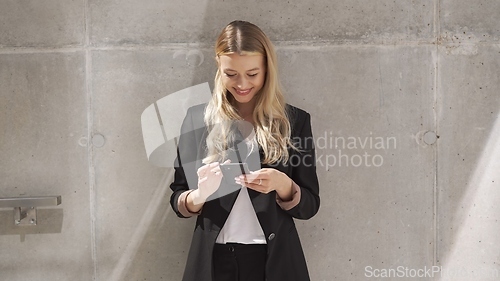 Image of Professional Woman Texting on Smartphone Outdoors