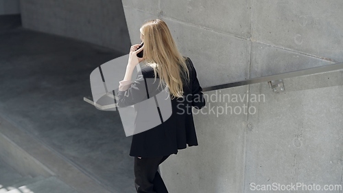 Image of Professional Woman Talking on Phone in Modern Setting