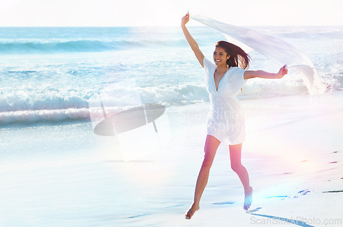 Image of Woman, beach and happy with fabric in wind for freedom, adventure or running with smile in nature by sea. Girl, person and excited with sarong on holiday, vacation or waves in lens flare in Indonesia