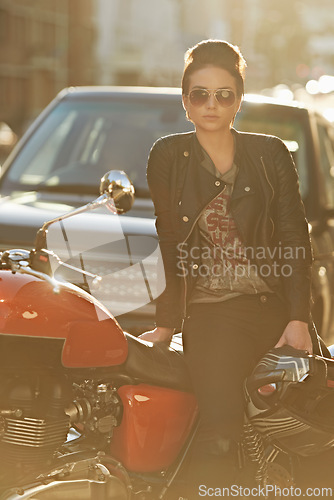 Image of Bike, leather and woman in city with sunglasses for travel, transport or road trip as rebel. Fashion, street and model with attitude on classic or vintage motorcycle for transportation or journey