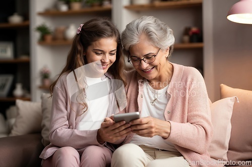 Image of Grandmother and Granddaughter Enjoying Time with Tablet