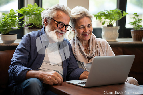 Image of Senior Couple Enjoying Time Together With Laptop