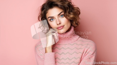 Image of Elegant Woman in Pink Sweater on Pastel Background