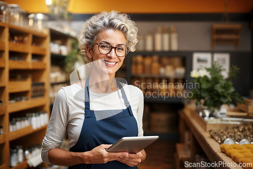 Image of Confident Female Entrepreneur With Tablet in a Cozy Store