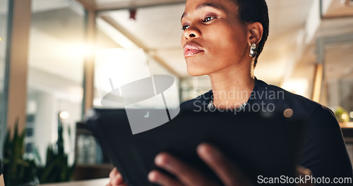 Image of Business, black woman and tablet at night in office to search internet, scroll information and planning website. Face of serious employee working late on digital tech, online data or social media app