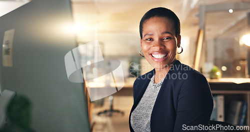 Image of Face, happy and black woman in office at night for business on a computer during overtime. Smile, workspace and portrait of an African employee with a pc for a late deadline or working in corporate