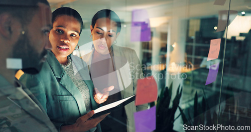 Image of Business woman, presentation and notes on board in an office for training, meeting or ideas. Men and women talking about strategy, planning or pitch with technology, leader and a team at night